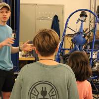 Students learn about Formula SAE from an engineering student